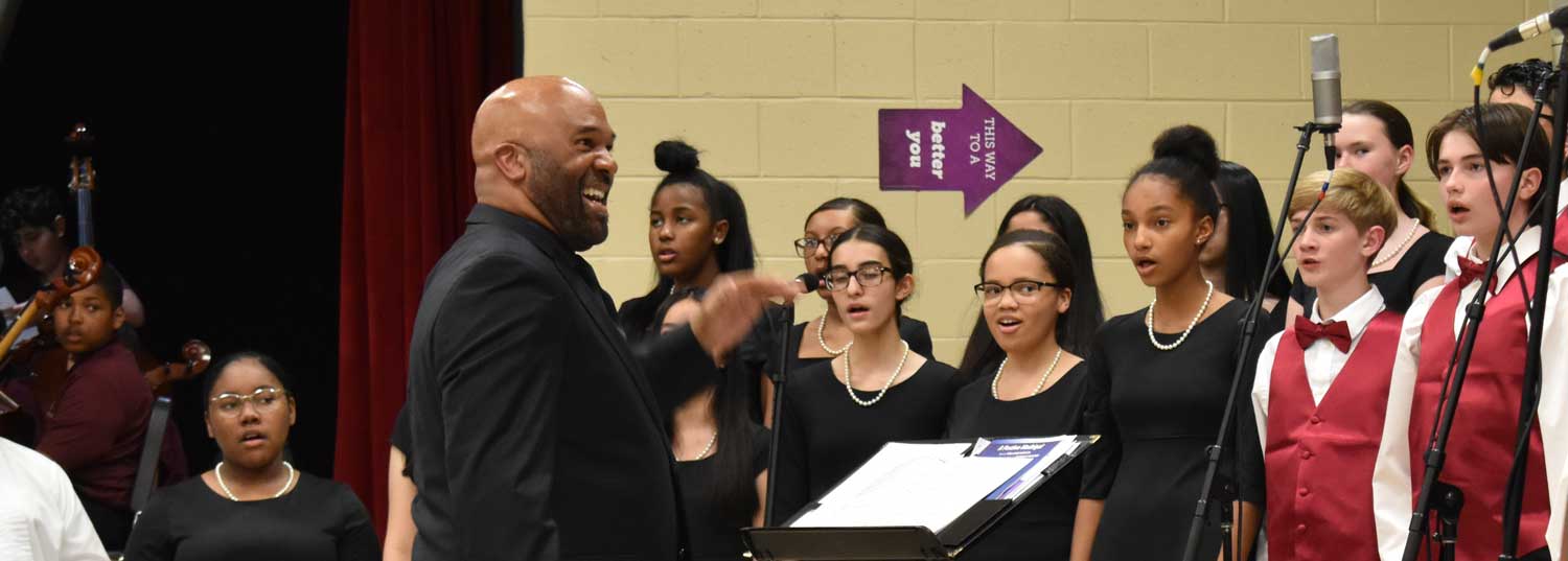 Timothy Simmons conducts choir.