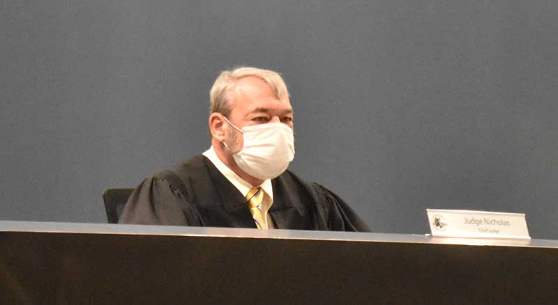 Judge at Tucker Municipal Court bench wearing a mask due to the pandemic.