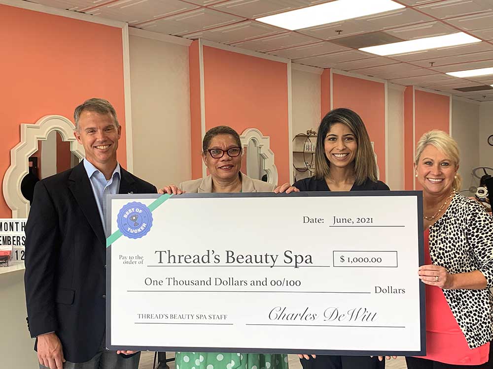 Thread Beauty Spa presented with Best of Tucker check.