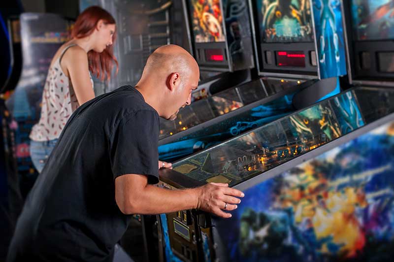 InTucker-June2022 Man playing games in an arcade.