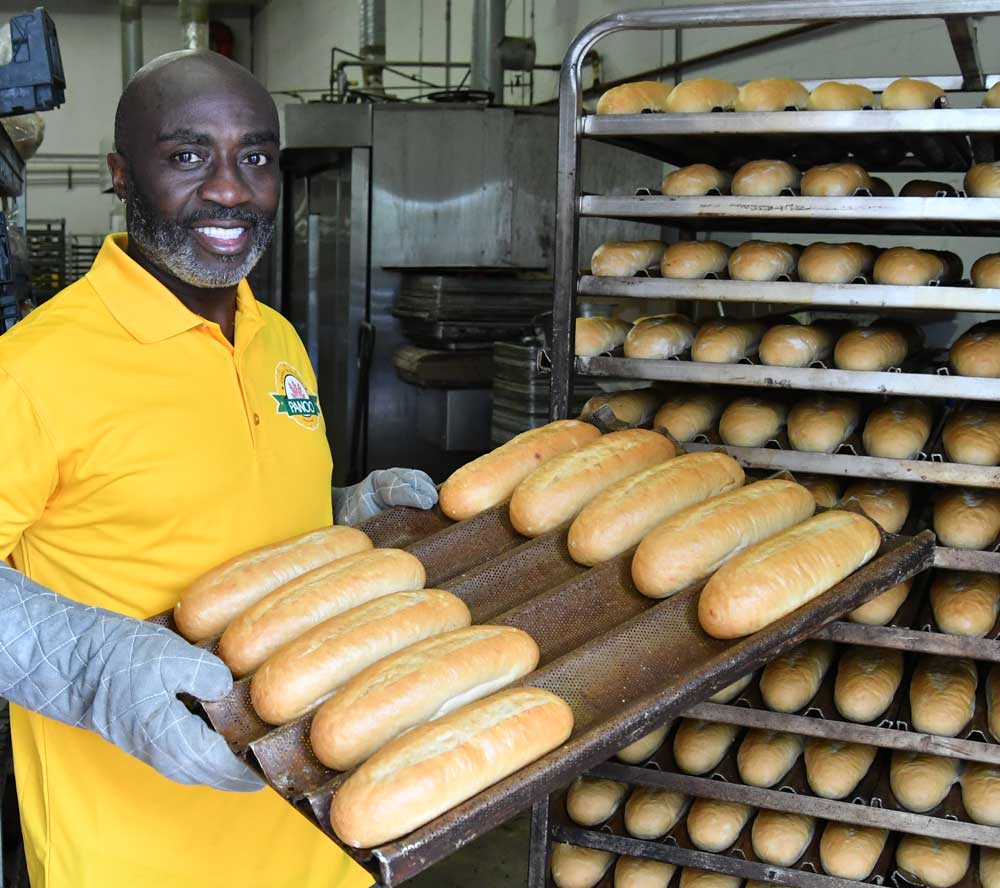 Davies Donkor of La Baguette Bakery shows off their bread.