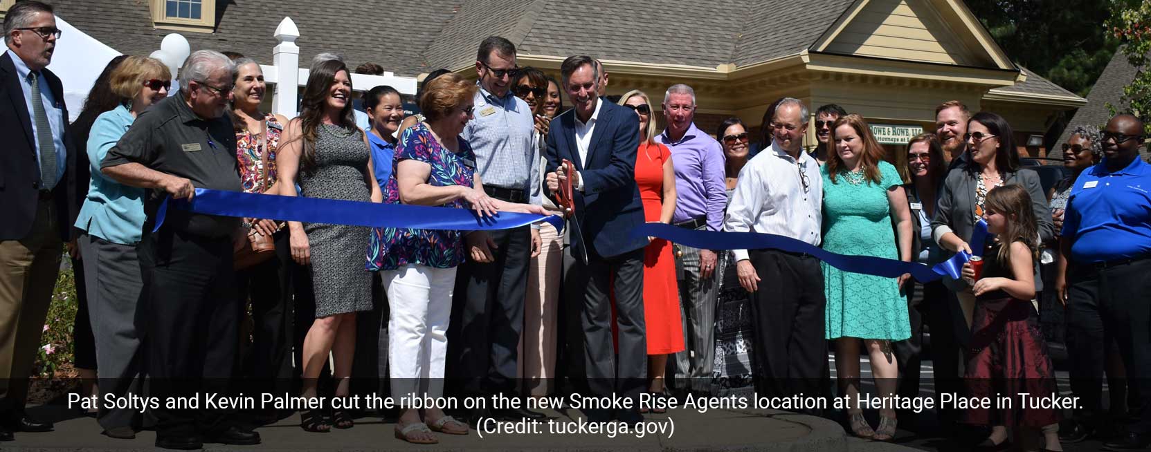 Photo of ribbon cutting at new location of Smoke Rise Agents real estate.