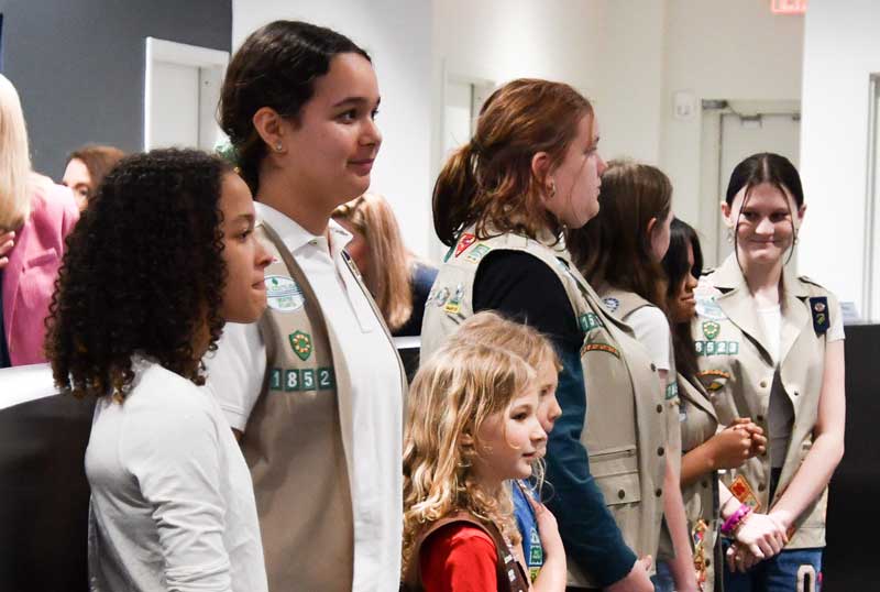 Girl Scouts lead the Pledge of Allegiance.
