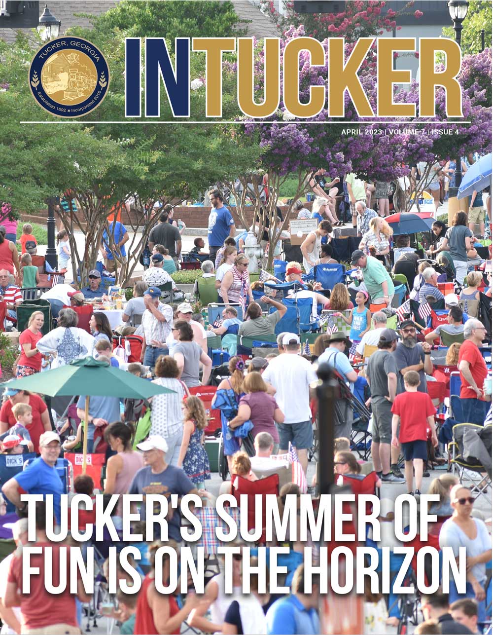 InTucker Cover of April 2023 shows a crowd on Main Street for a fireworks show.