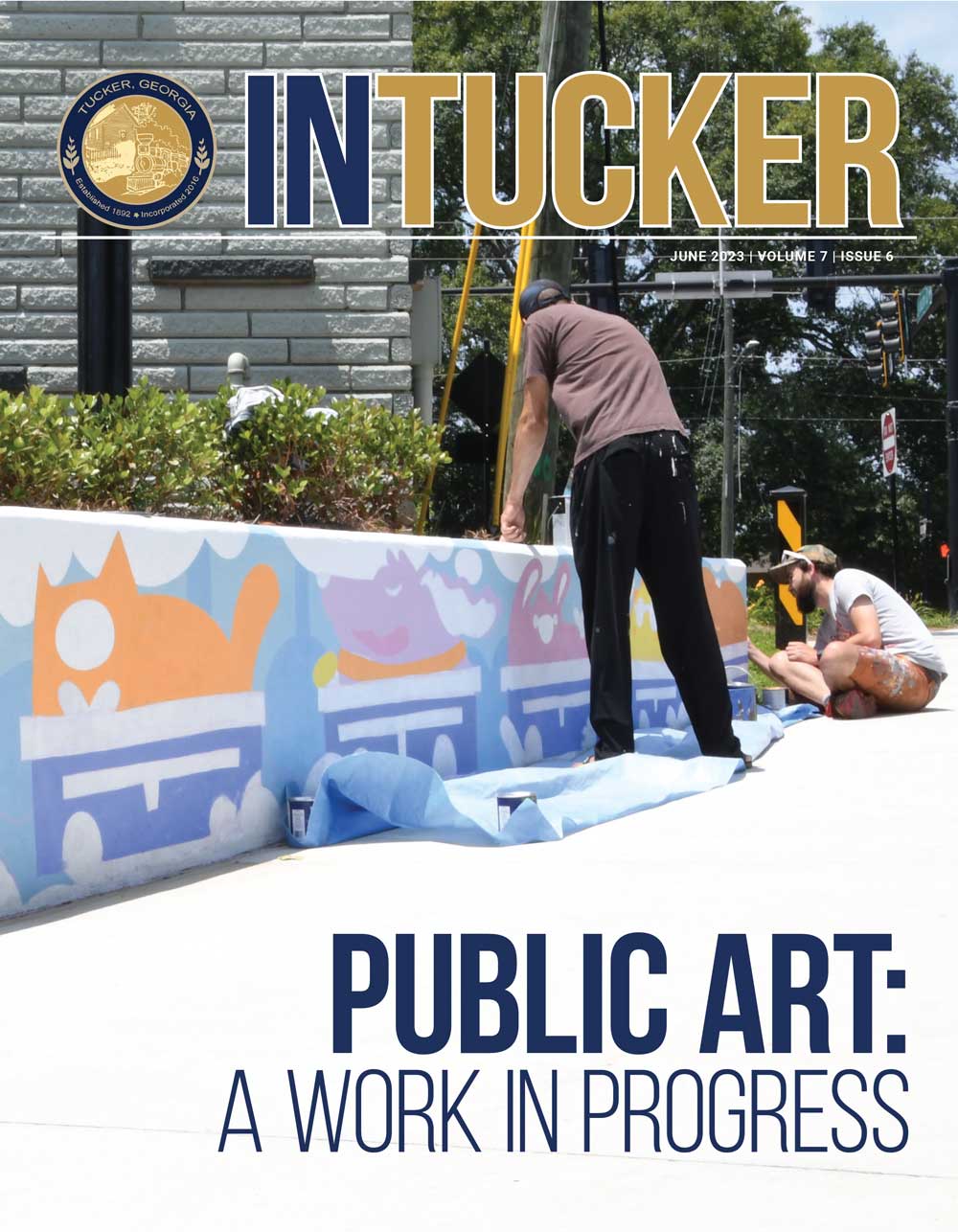 InTucker Cover of June 2023 shows the painting of a downtown mural by Catlanta.