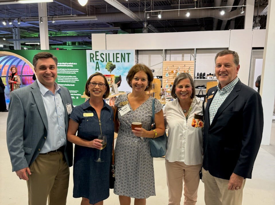 Councilmembers Cara Schroeder and Amy Trocchi pose with Mayor Auman at the Resilient Earth exhibit in the Science Gallery Atlanta.