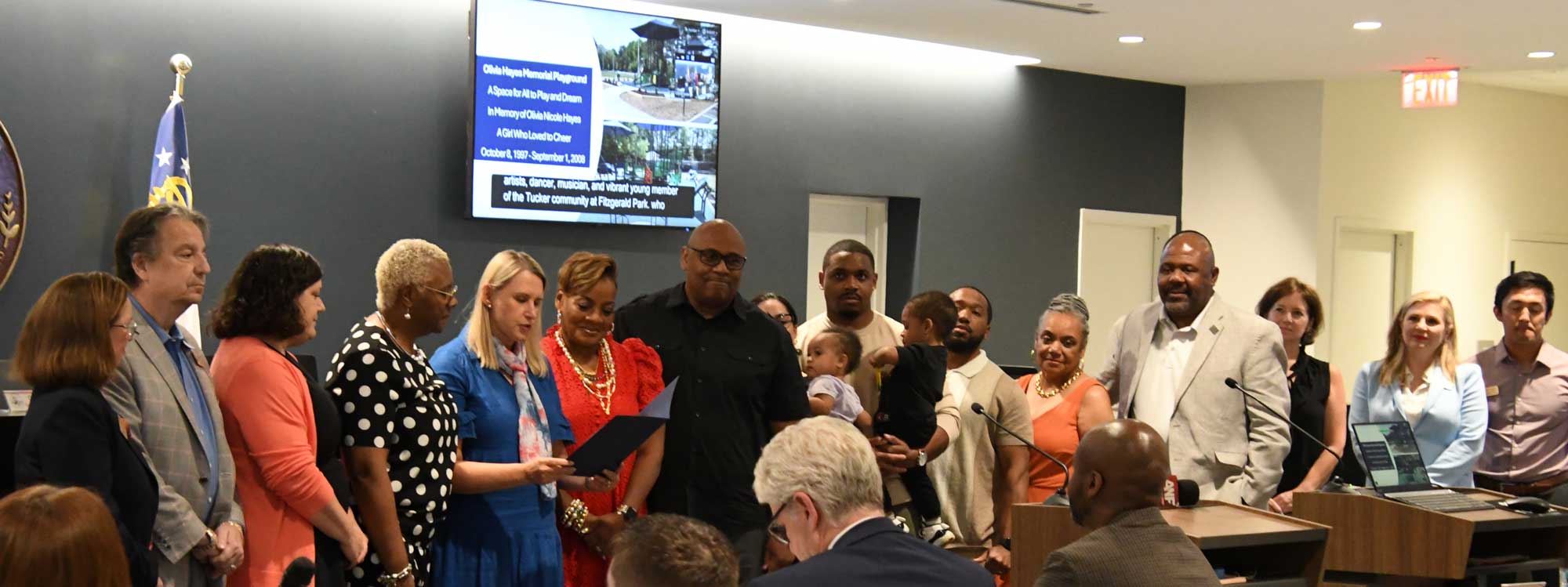 The Hayes family listens as Mayor Lerner reads the resolution to name the new ADA playground at Fitzgerald Park in honor of Olivia Hayes.