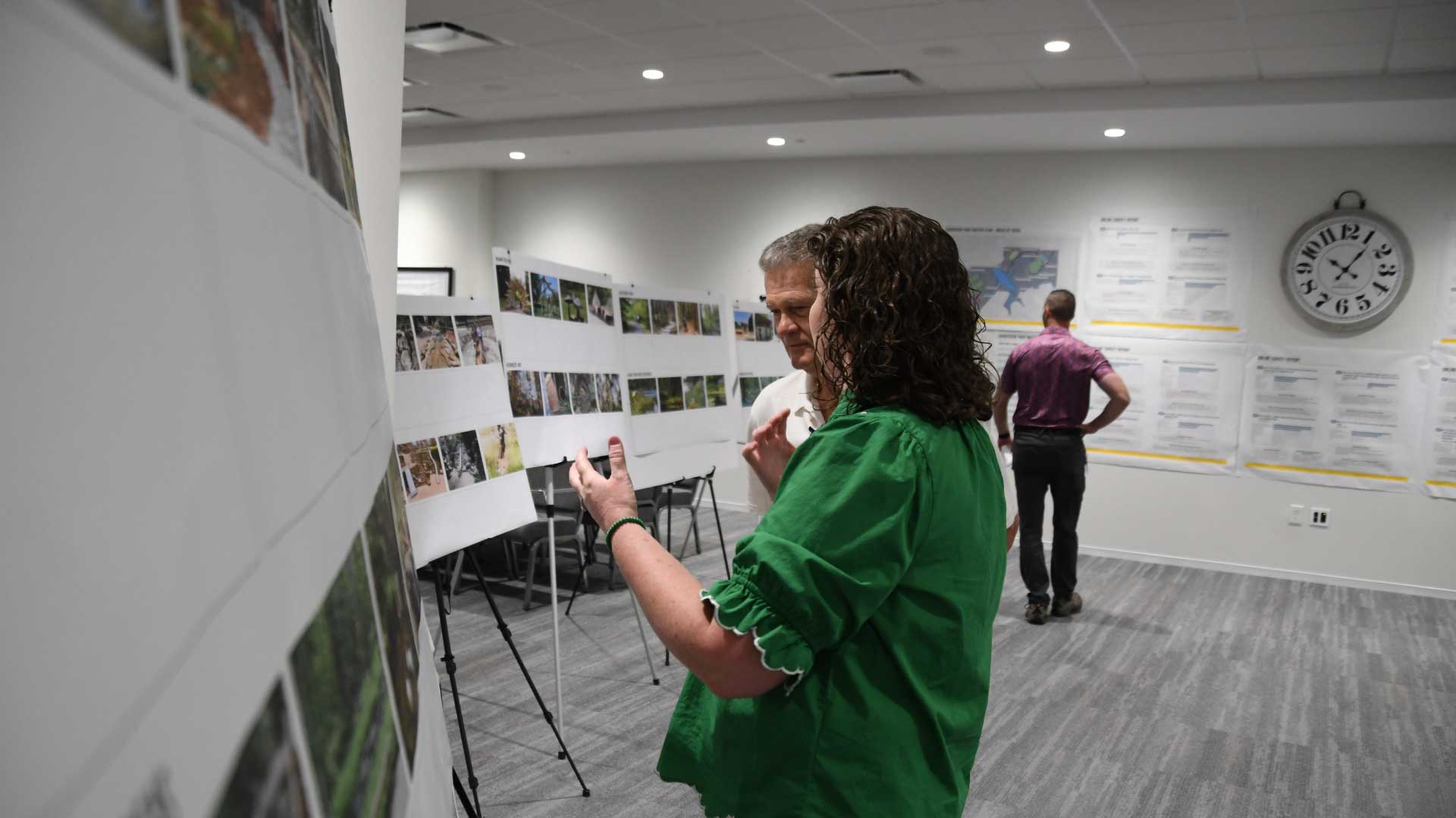 Henderson Park MasterPlan Open House participants look at maps of the park.