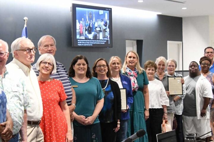 Representatives and volunteers of FODAC pose with the Tucker Mayor and Council along with patrons and staff of Peter & Paul's Place.